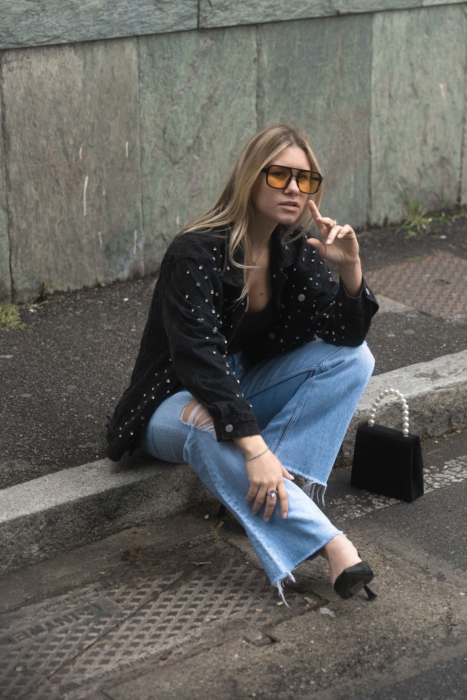Woman in a dark jacket and jeans on a city street