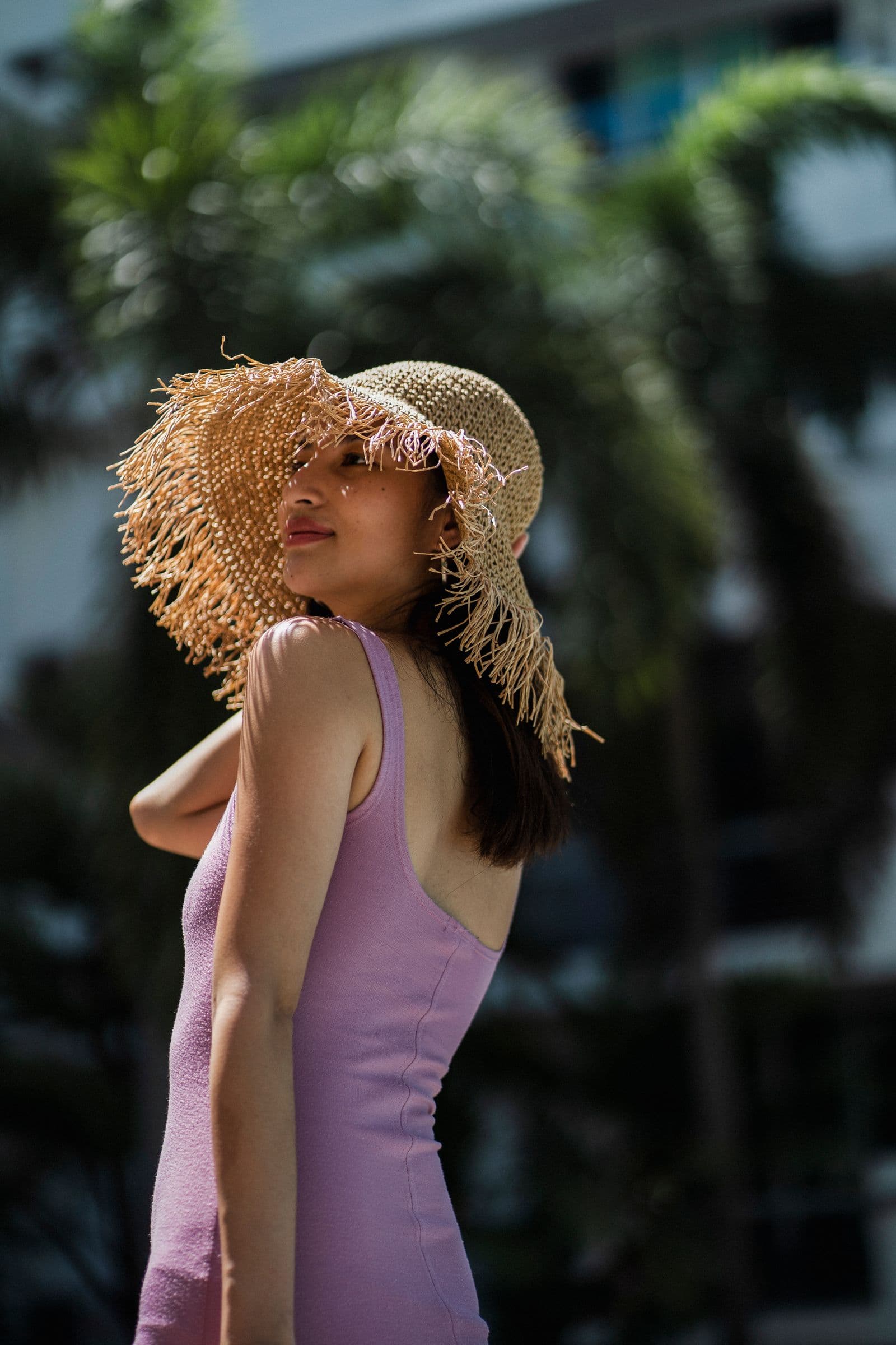 Traveler in a light summer outfit at a tropical resort