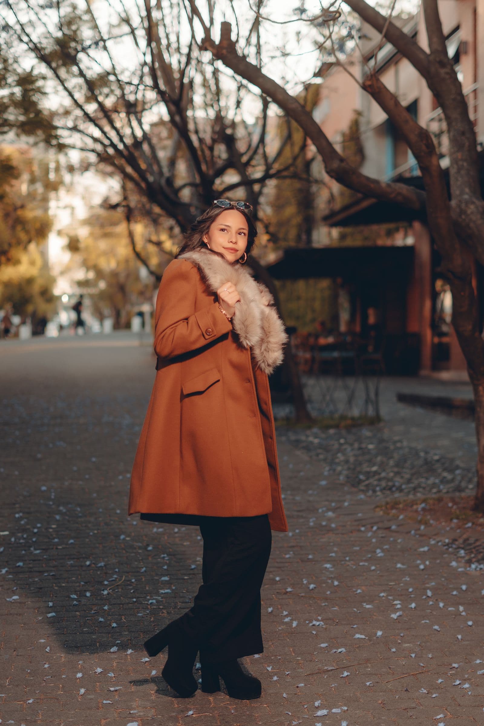 Woman in a weather-ready coat walking through a city