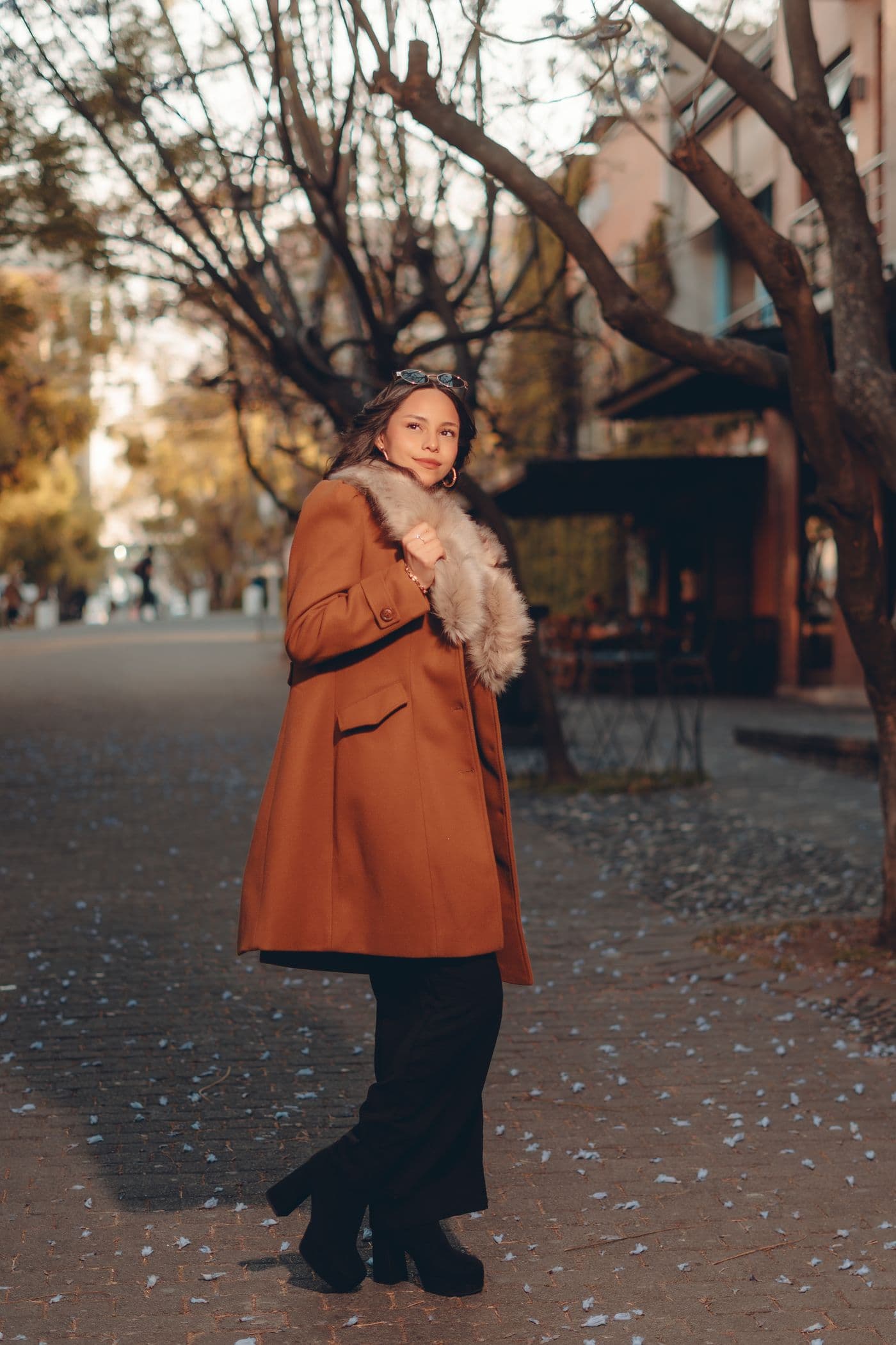 Woman in a warm coat walking through a windy city