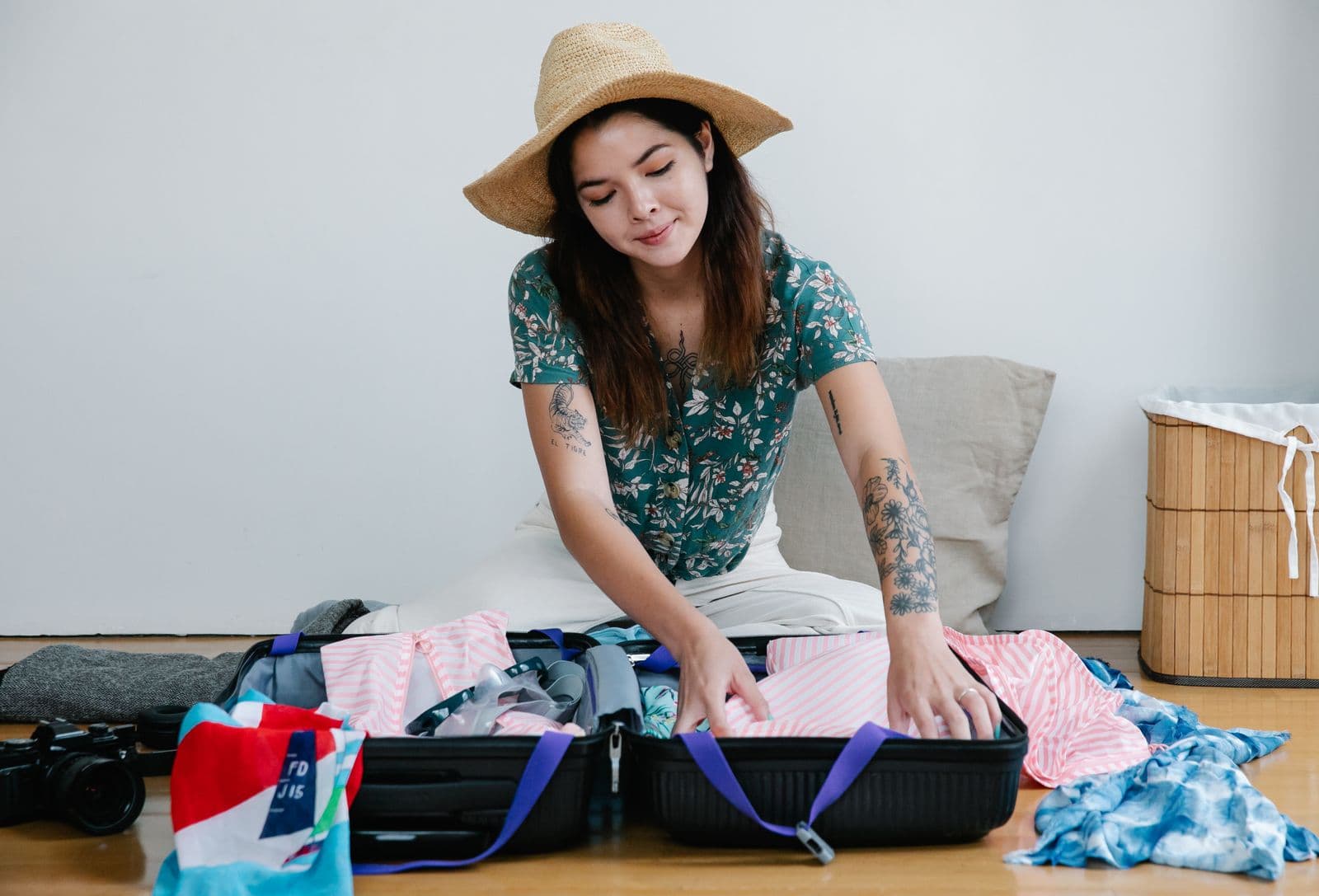 Woman organizing clothing in an open carry-on suitcase