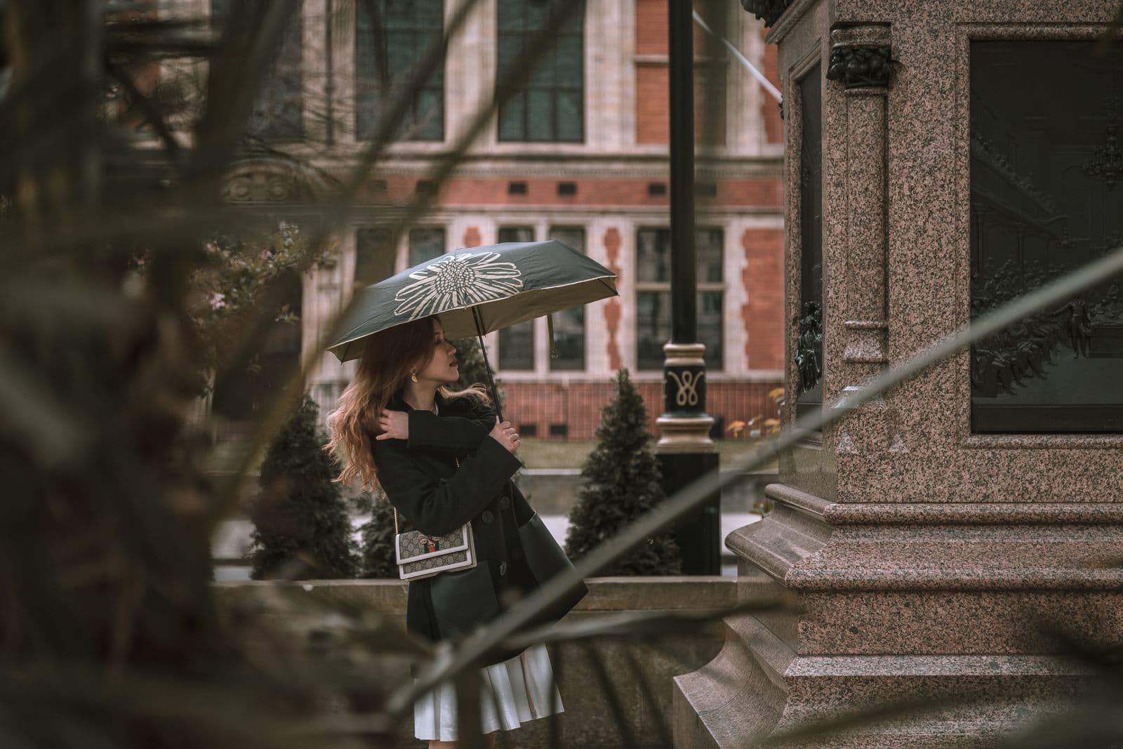 Woman carrying an umbrella in cool changeable weather