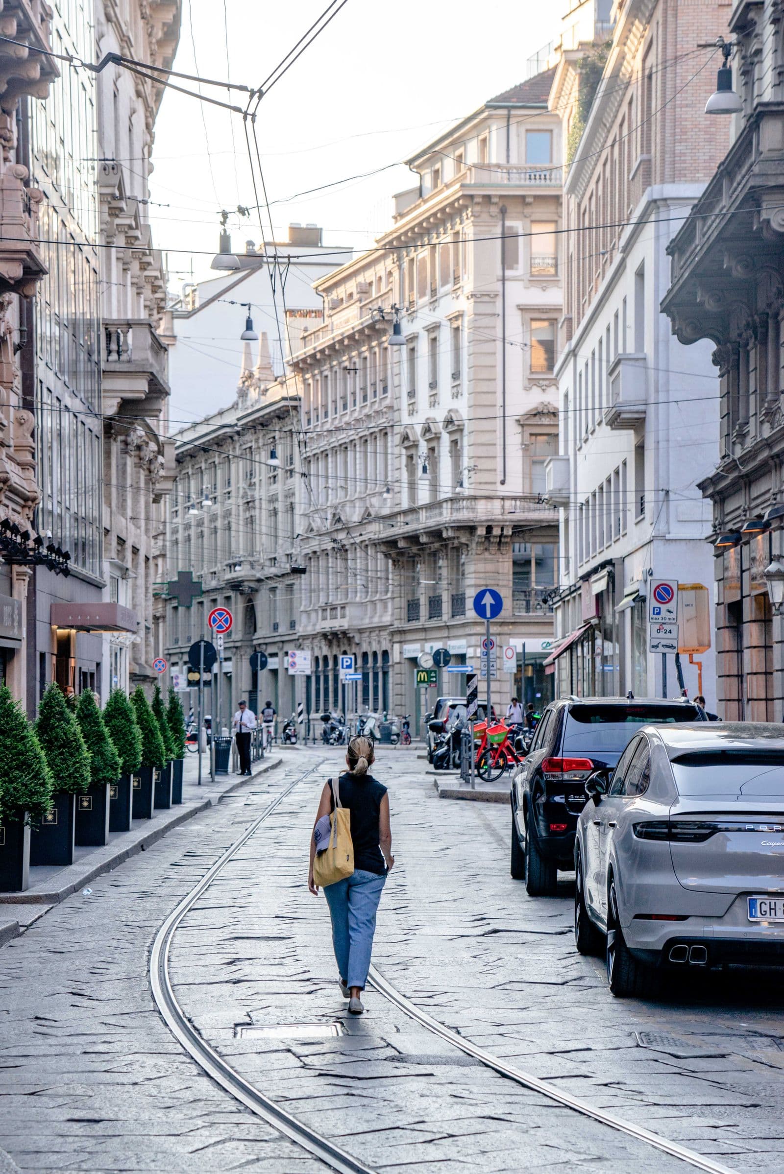 Woman walking through a European town in a light city outfit
