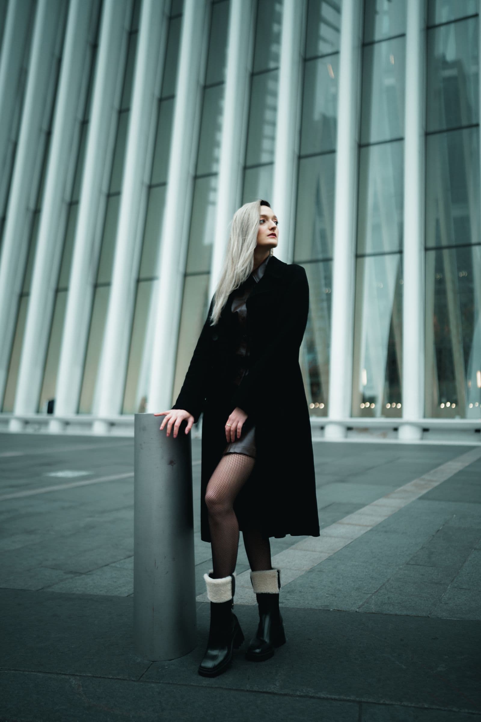 Woman in a transitional coat on a New York street