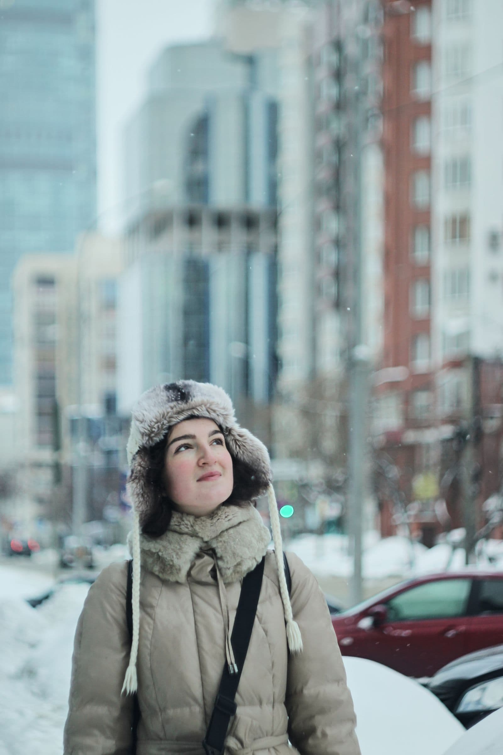 Woman in warm clothing walking through a winter city